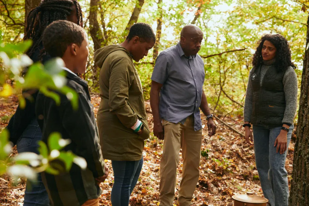 family grieiving at a memorial tree