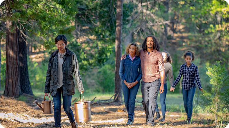 A family walks through a memorial forest with cremated ashes