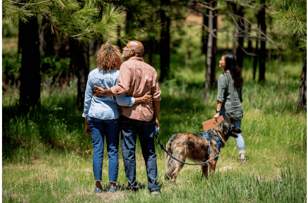 family with their dog in the forest. They are talking about Spreading their Pet's Ashes