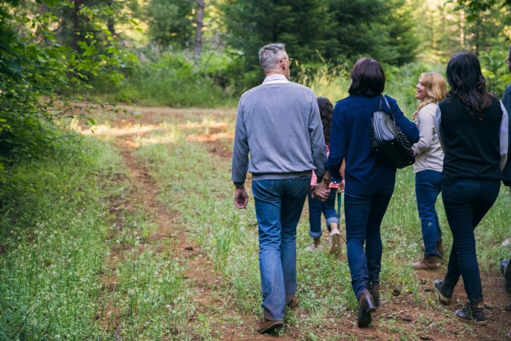 family walk in a forest. They are talking about swedish death cleaning