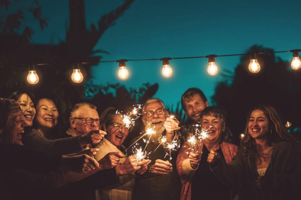 Family and friends gather outdoors in the evening for a celebration of life