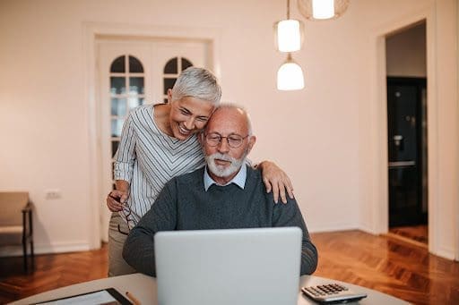 Senior couple works on computer together