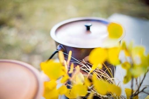 Table set for forest ceremony with an urn and aspen leaves. An idea for a type of urn display at funeral
