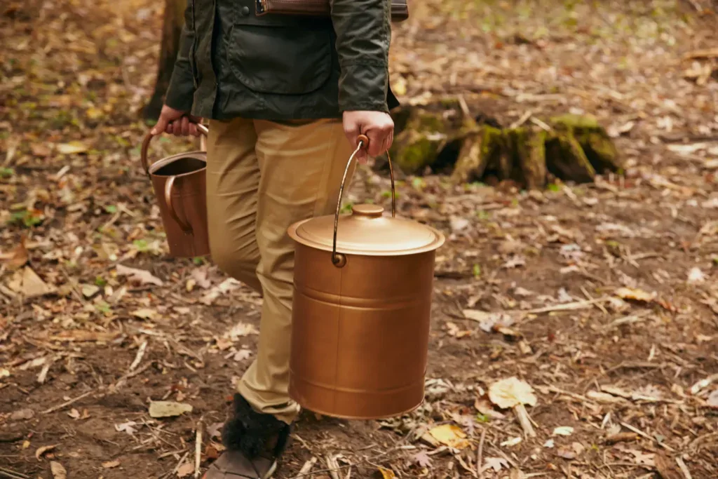 A forest guide carries an urn used for mixing ashes and soil. A place to spread aquamation