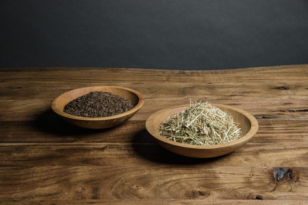 A photo of two bowls holding examples of the organic material that is combined with a human body as part of the human composting process.