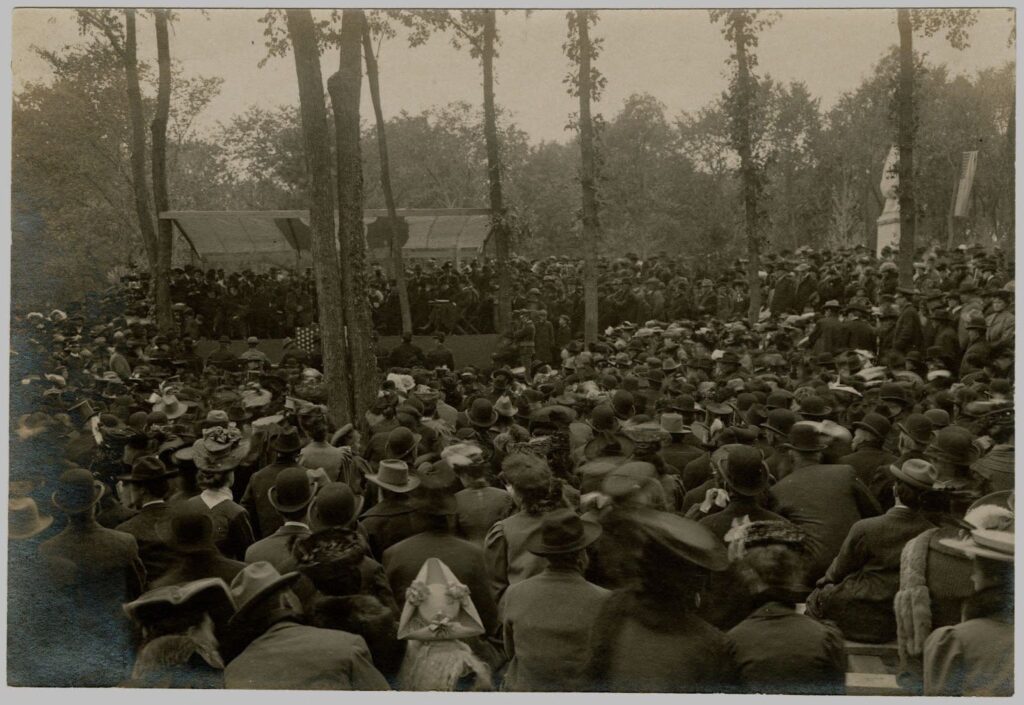 a large crowd of people in a forest