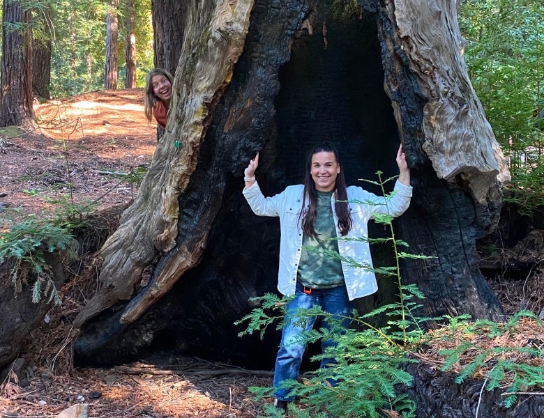 Kelly stands by a memorial tree in a better place forests point arena memorial forest