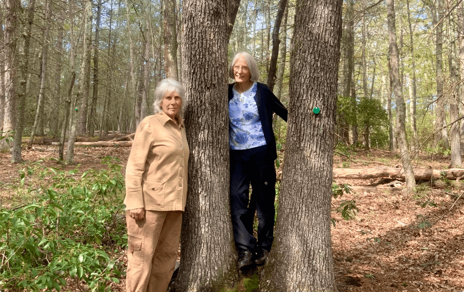 Susan and Mary stand together at their memorial tree in Better Place Forest memorial forest in Litchfield Hills, CT