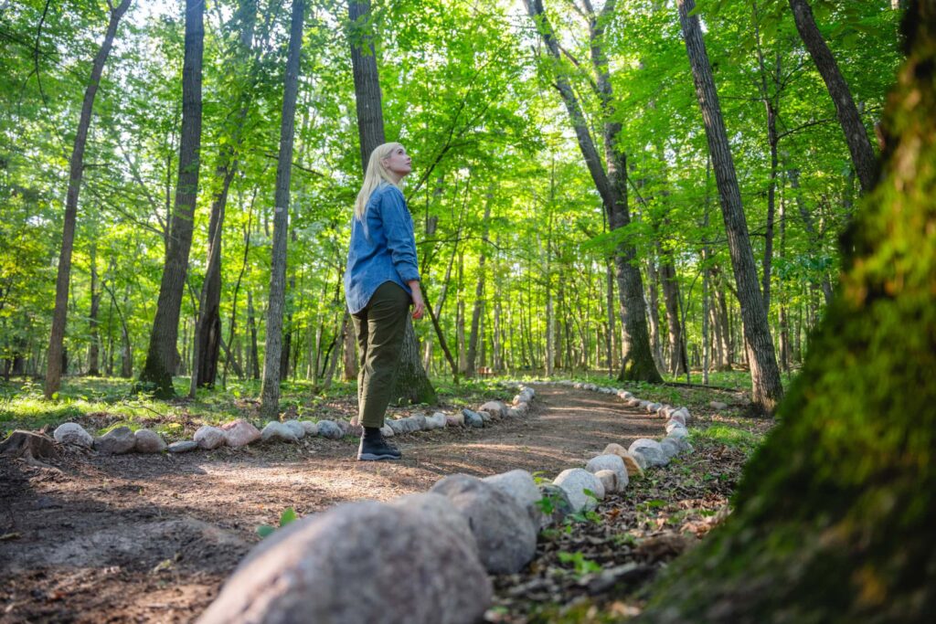 a woman walks through the spreading grove at better place forests