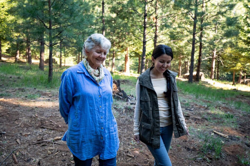 a mom and daughter walk through a forest and talk about how to start preparing for death