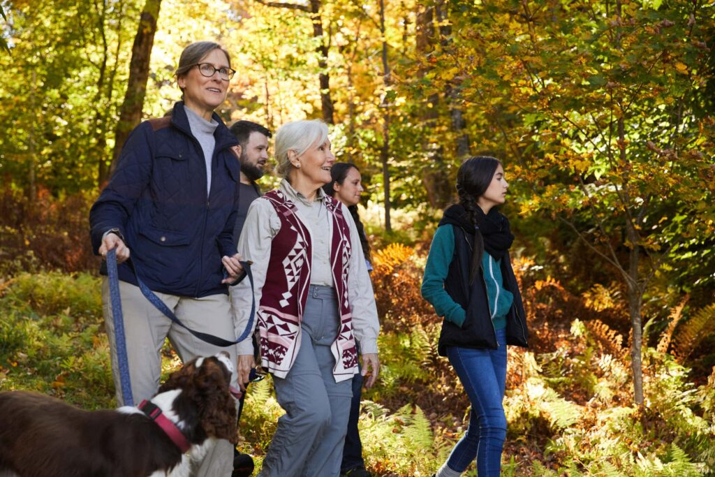 a family walks through a forest thinking about the option of natural burial