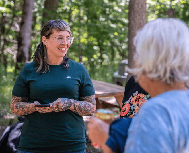 A forest guide assists a customer in the forest