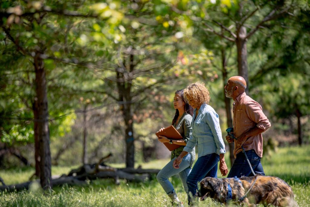 a family and guide take a tour of Better Place Forests