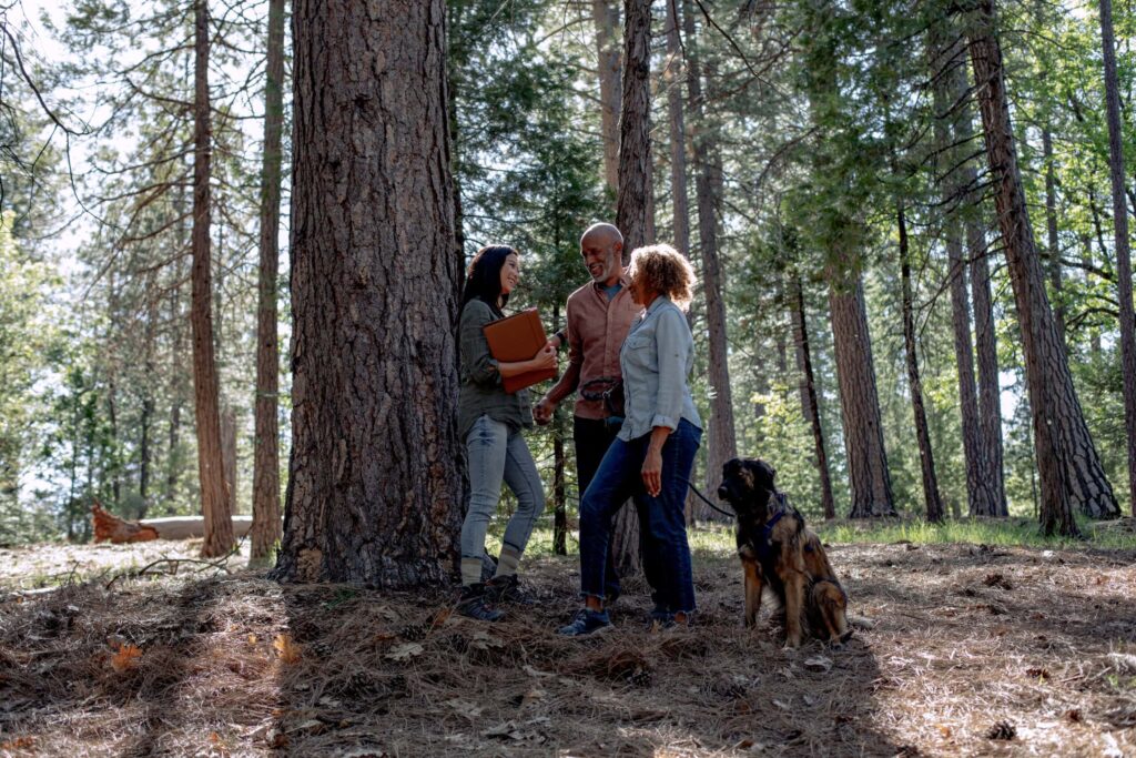 a guide stands with a family in Better Place Forests