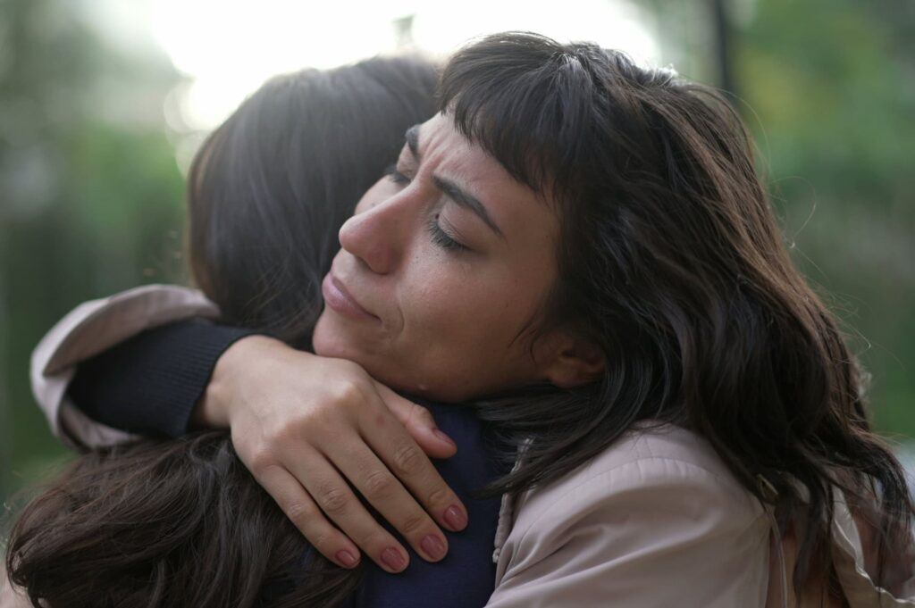 Sympathetic woman hugging a grieving friend