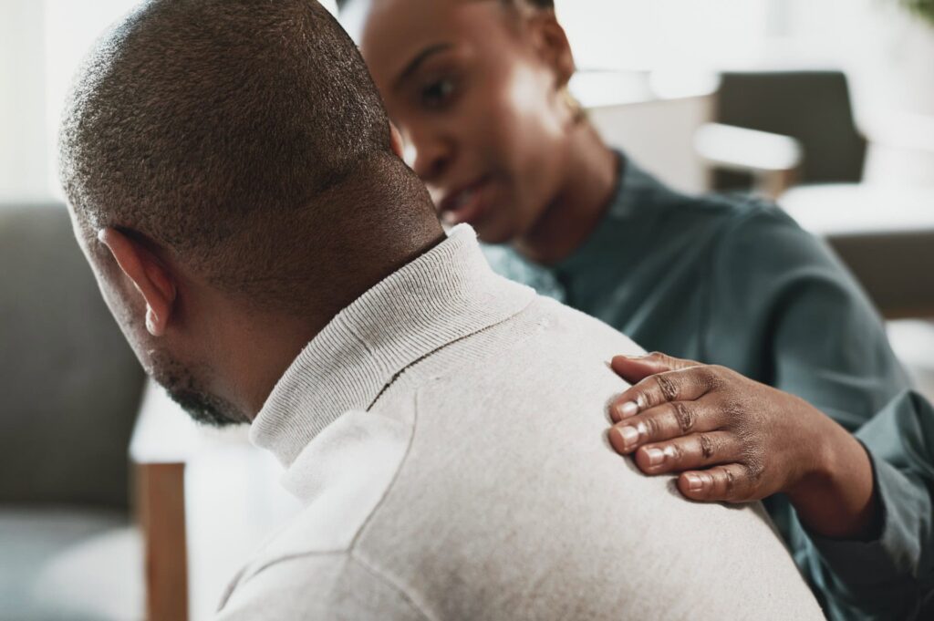 A man and woman comfort each other in grief support 