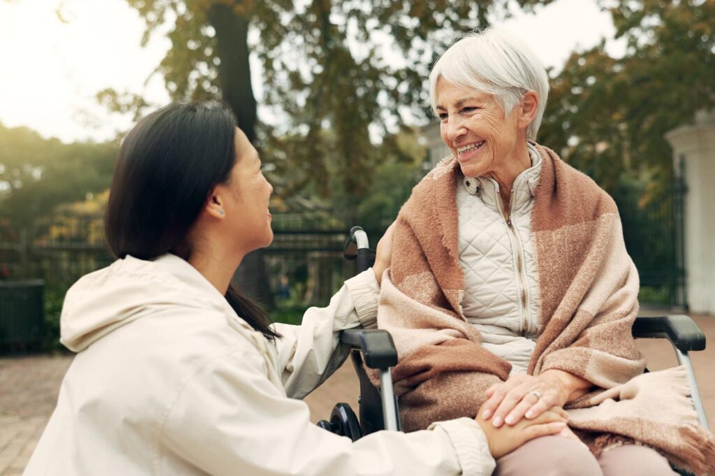 woman comforting senior woman who is sick