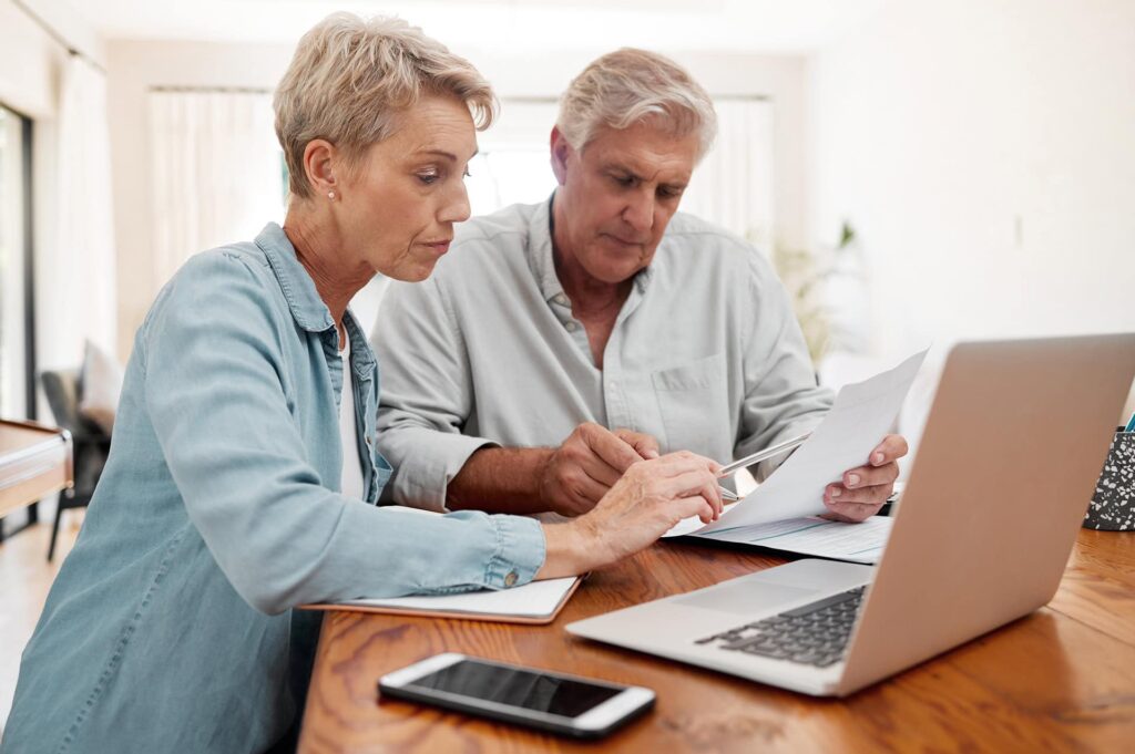 Senior man and woman with documents review end-of-life plan