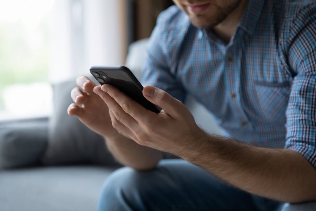 Man using his mobile phone texting