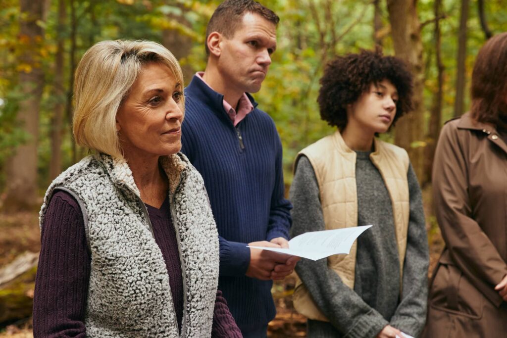 Family at a Forest Memorial ceremony sharing readings