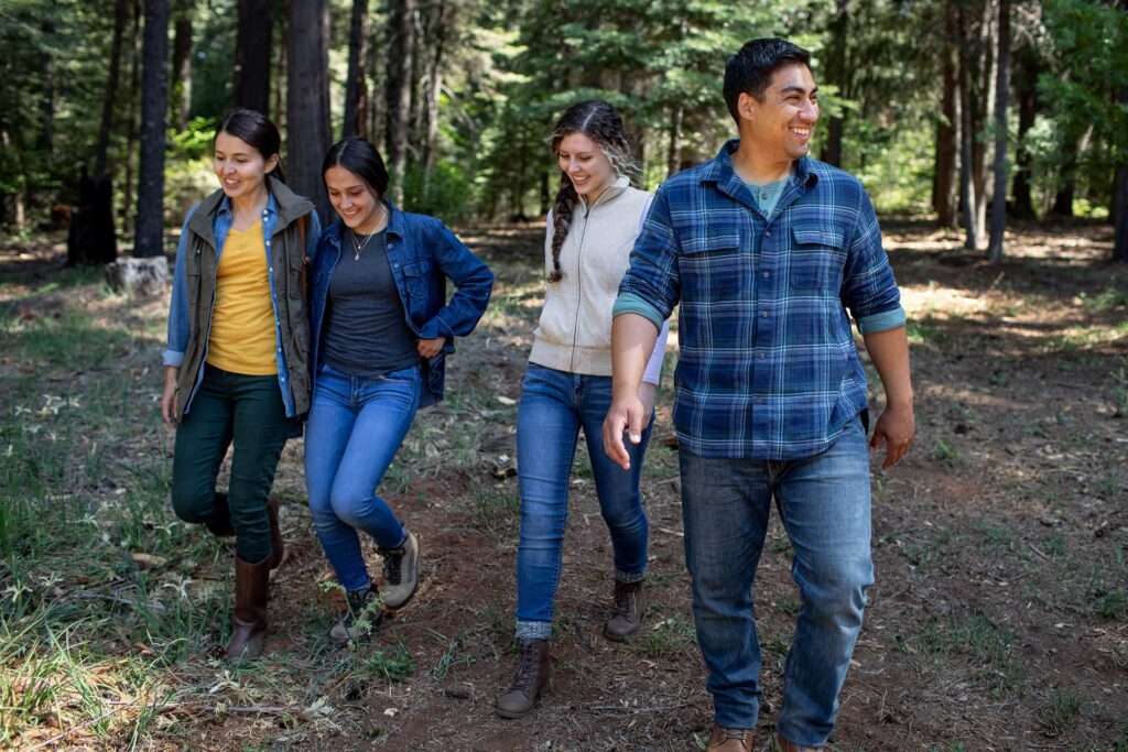 Group of four siblings walking on a trail in a Memorial Forest