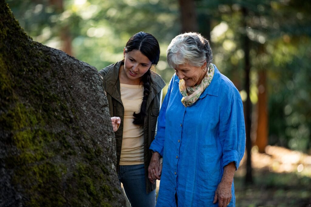Grandmother and granddaughter looking at a Memorial Tree in a Memorial Forest