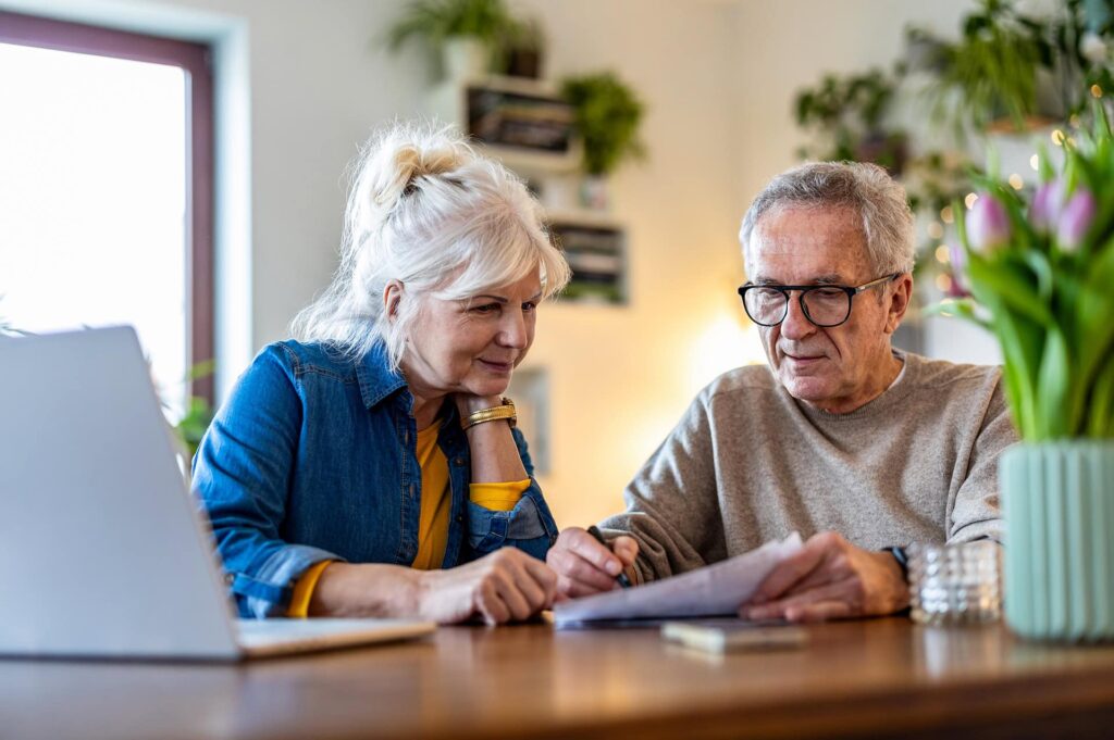 Senior couple sitting at the table discussing end-of-life planning