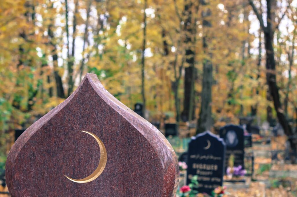 Golden muslim crescent moon on a granite tombstone