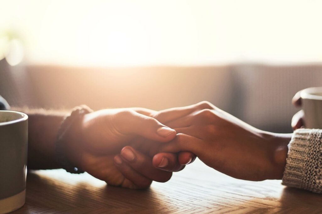 hands embracing in support for grief