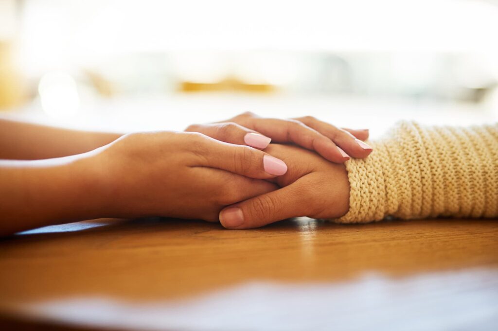 hands embracing in support for grief