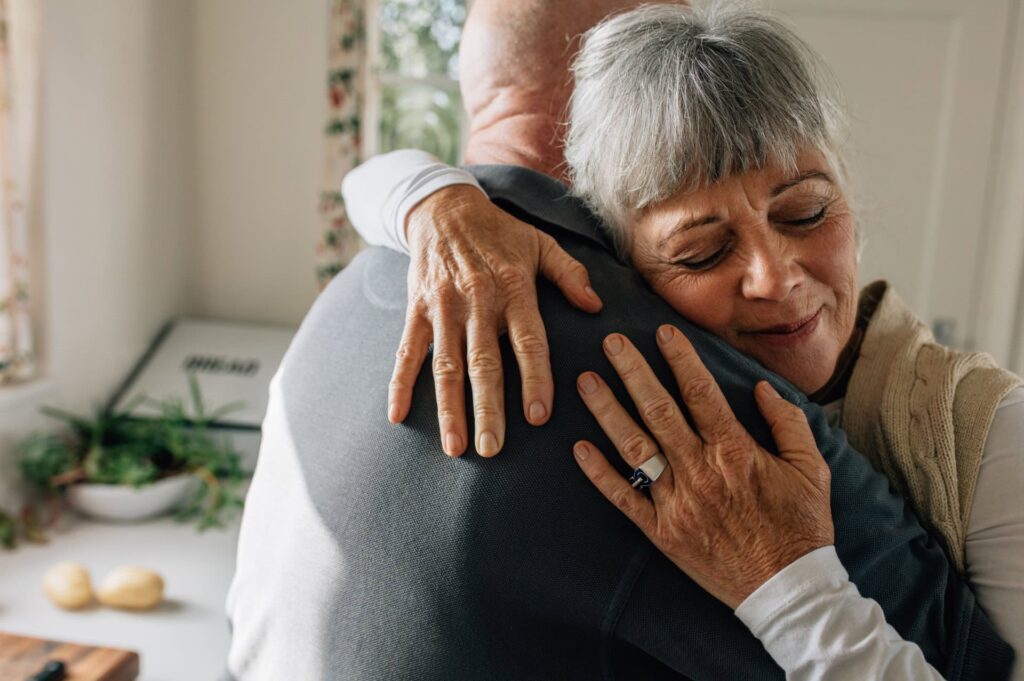 man embraces woman in support