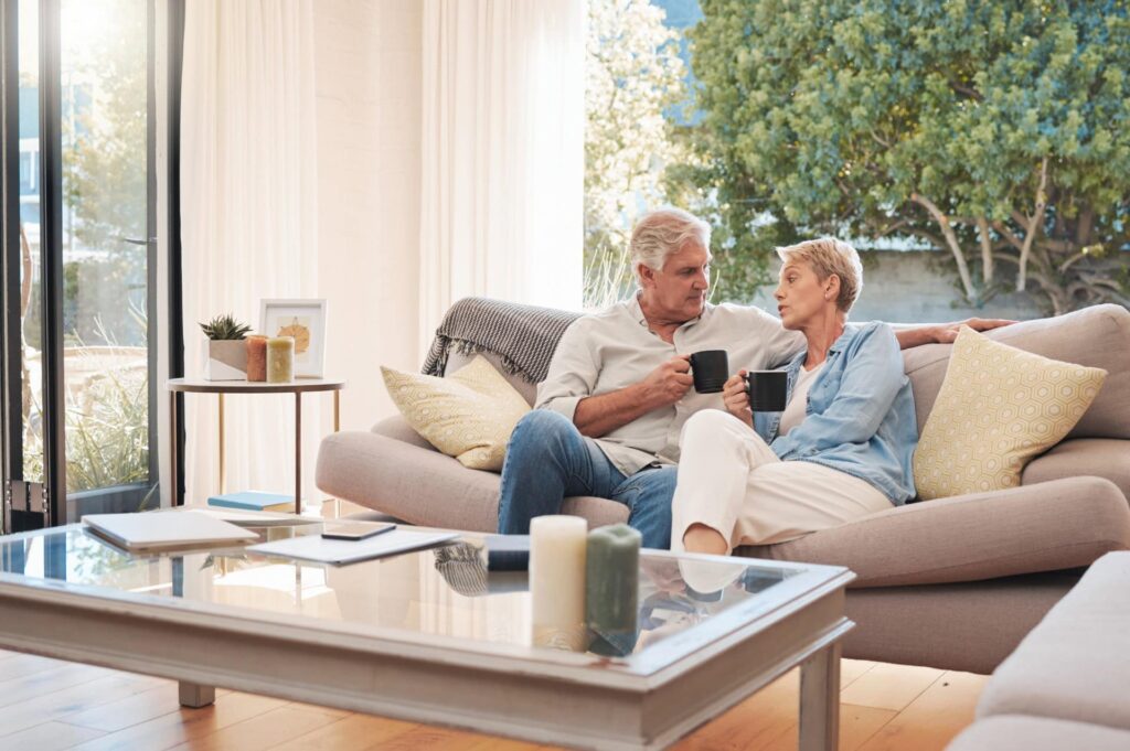 An elderly couple sits together for end of life planning