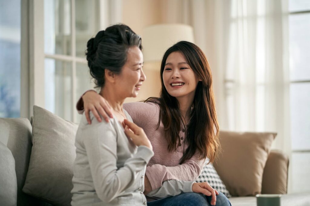A daughter comforts her mother as they write an obituary for her husband