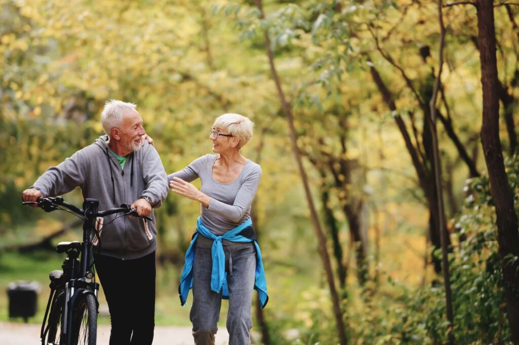 Older Couple exercising in park 