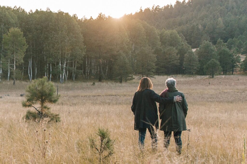 A mother and daughter hold hands in a memorial forest