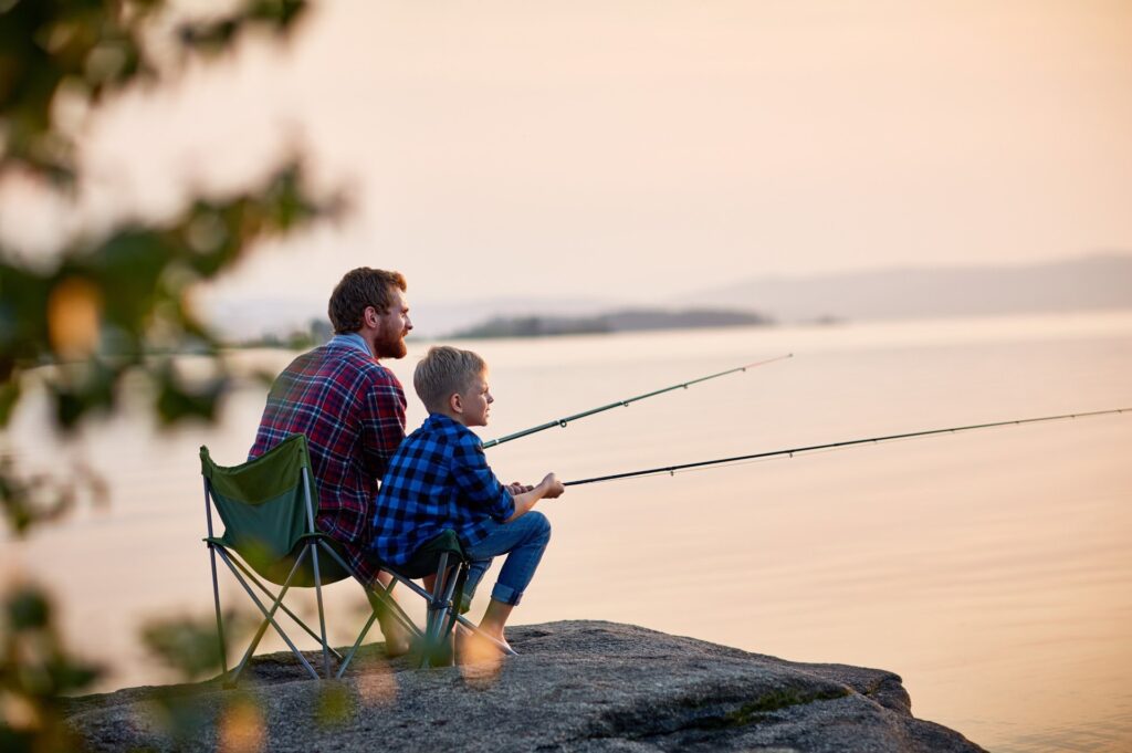 A dad and son fishing at a lake near Lake Arrowhead Memorial Forest