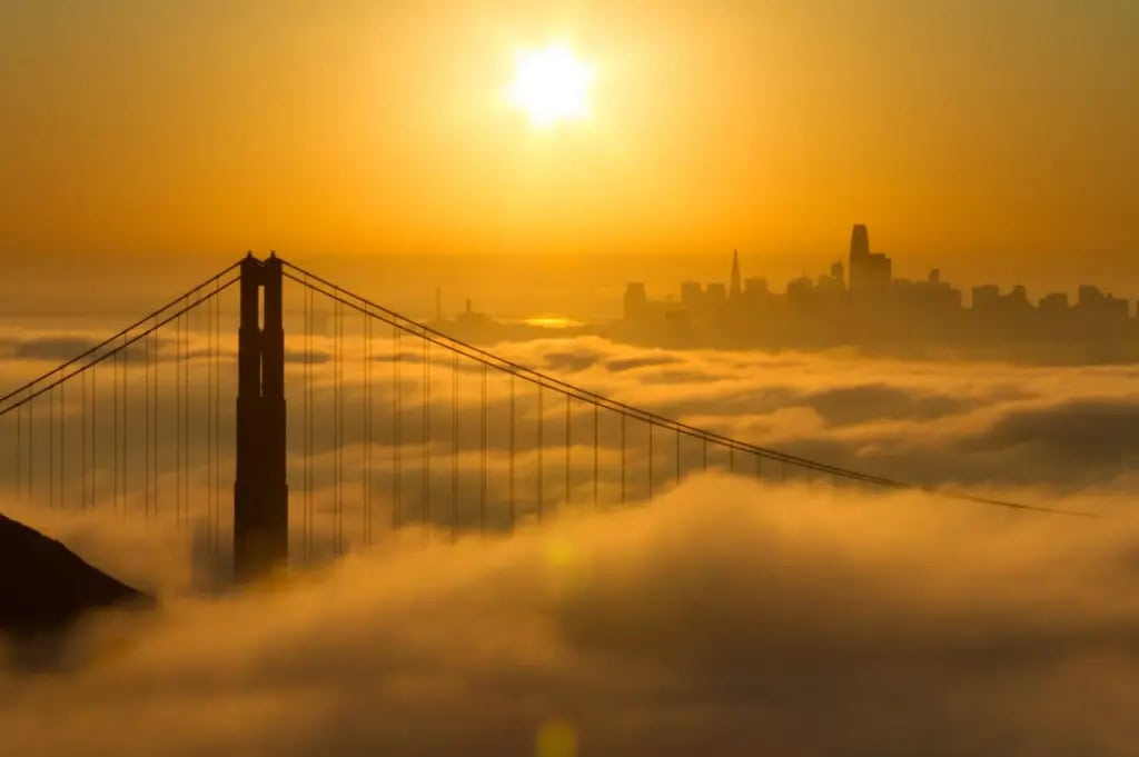 Sunsetting over a foggy golden gate bridge in San Francisco